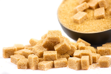 Brown sugar in a wooden bowl or wooden spoon Sugar for health Use for cooking or desserts on white and sugar backgrounds.