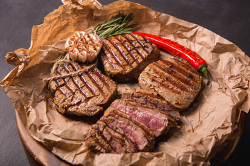 grilled meat medallions grilled vegetables dark background craft bbq
