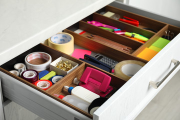 Different stationery in open desk drawer indoors, closeup
