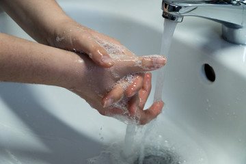 Fototapeta premium Washing Hands In Clean Sink