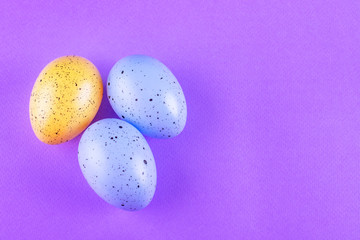 Easter multi-colored eggs on a lilac background