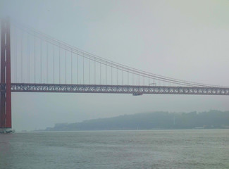Lisbon, Portugal-23 December 2019. Bridge on 25 April 2019 crossing the river Tejo on a foggy day.