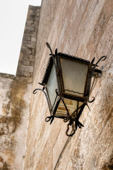 Fototapeta na wymiar Old lantern in the streets of the old town of Ostuni, the white city. Puglia, Italy