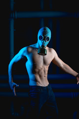 a man in gas mask  looking into the frame