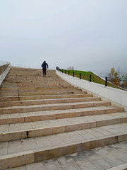 Person who trains physically with scale seen from below.