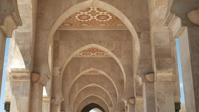 wide view of a covered walkway at hassan ii mosque in casablanca, morroco