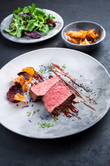Barbecue dry aged wagyu roast beef natural sliced and offered with vegetable chips and lettuce as...