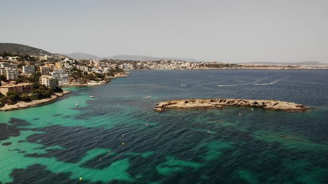 Aerial drone view of summer seascape. Turquoise sea water, luxury hotels on the rocky seashore. Playa de Illetas beach, Mallorca Island
