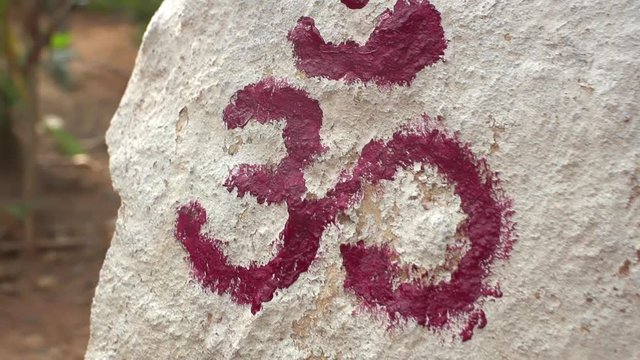 The ancient sign OM, a Buddhist symbol, in Asia, in ruins was created by monks