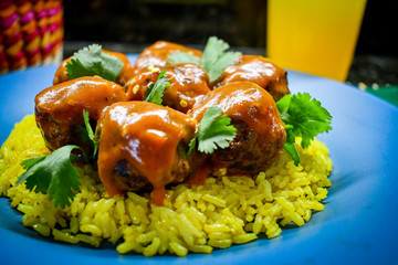 Meatballs with chipotle salsa over yellow rice