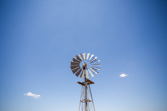 Wide amgle view of a lone windpomp / windmill on the plains of t
