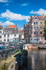 Brick buildings at the edge of canals in Amsterdam
