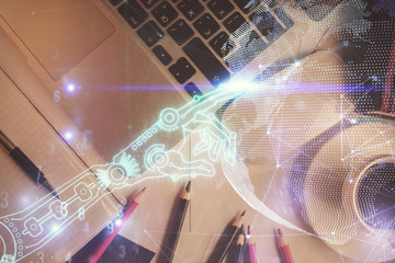 Technology hologram drawing over computer on the desktop background. Top view. Double exposure. Tech concept.