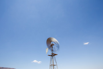 Wide amgle view of a lone windpomp / windmill on the plains of t