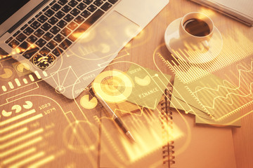 Technology hologram drawing over computer on the desktop background. Top view. Double exposure. Tech concept.