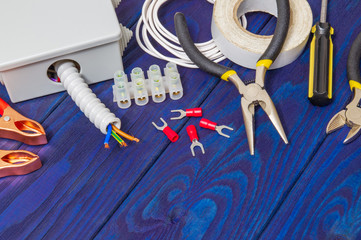 Professional kit spare parts and tools for electrical prepared before repair or setting on blue wooden planks