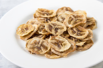 Dried  banana slices  on white plate. Healthy lifestyle.
