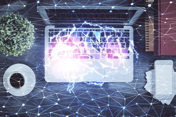 Double exposure of brain drawing hologram over topview work table background with computer. Concept of big data.