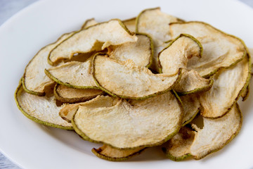 Dried  pear slices  on white plate. Healthy lifestyle.