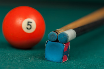 Billiards balls and cue on billiards table. Billiard sport concept.