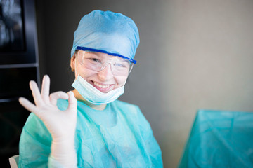 Successful smiling young woman doctor intern in uniform at medical office