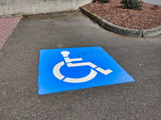 blue handicapped parking paint marker in a parking lot outdoors