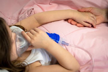 Obraz na płótnie Canvas sick little girl is using a medical ventilator