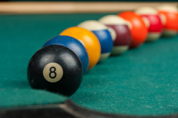 Billiards balls and cue on billiards table. Billiard sport concept.