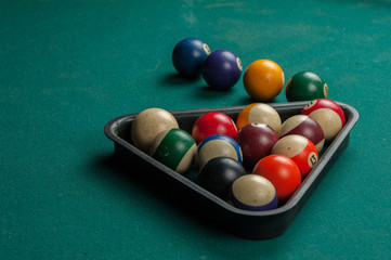 Billiards balls and cue on billiards table. Billiard sport concept.
