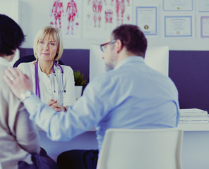 doctor talking to her male patient at office