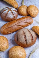 Different kinds of fresh bread as background, top view