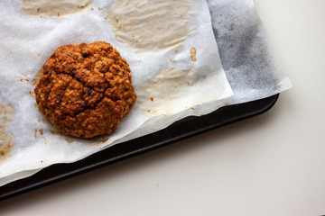 one last homemade baked oat cookies on white paper