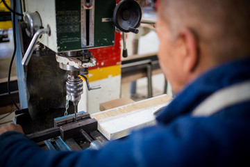 Close up image of a drill press being used in a factory