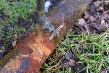 rusty water pipe with leaking tap