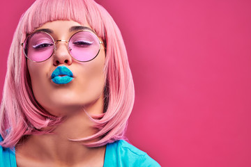 Close up view portrait of cute young woman sending kiss and flirting.