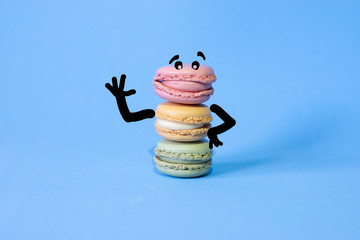 cartoon drawn on coloured macarons on a blue background