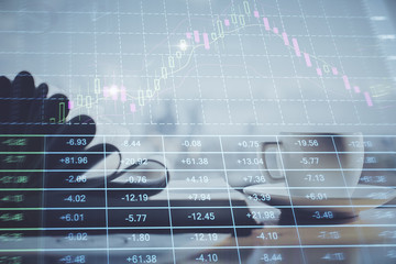 Double exposure of financial chart drawing and desktop with coffee and items on table background. Concept of forex market trading