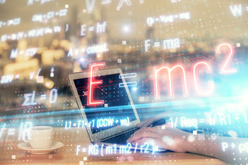 Double exposure of woman hands typing on computer and formula hologram drawing. Education concept.