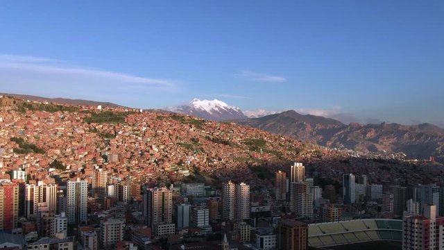 Aerial view of La Paz cityscape and Illimani Mountain at sunset, Bolivia, South America.