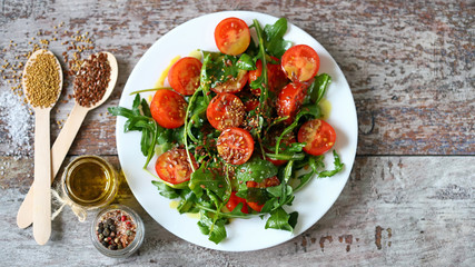 Selective focus. Healthy fresh arugula cherry salad on a plate. Vegan diet. Healthy food.