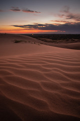 Fototapeta na wymiar Beautiful sunset over sand dunes