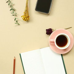 Work and study place. note book, cup of coffee, smart phone with floral decoration. flat lay, top view, copy space