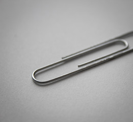 metal paper clip on white empty space paper background