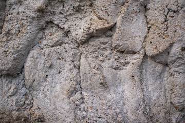 Uneven concrete wall. Influx of cement, small stones, sand. Color Shady Lady, hue Gray.