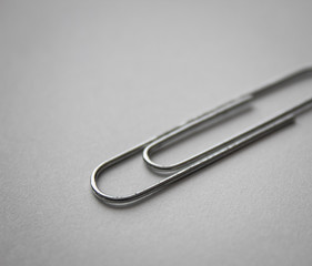 metal paper clip isolated on white paper background