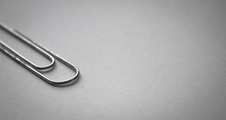 metal paperclip up close photos on white paper