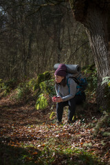 a young pilgrim rests and meditates on a small path before continuing on the Way of Saint James
