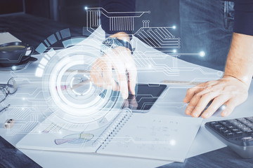 Double exposure of man's hand holding and using a digital device and data theme drawing. Technology...