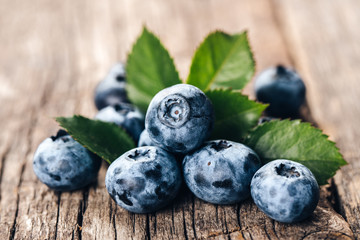 Freshly picked blueberries on wooden background. Healthy eating and nutrition.