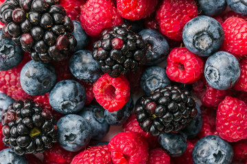 Fresh Summer Berries mix Background with Strawberry, Raspberry, Red currant, Blueberry and Blackberry.